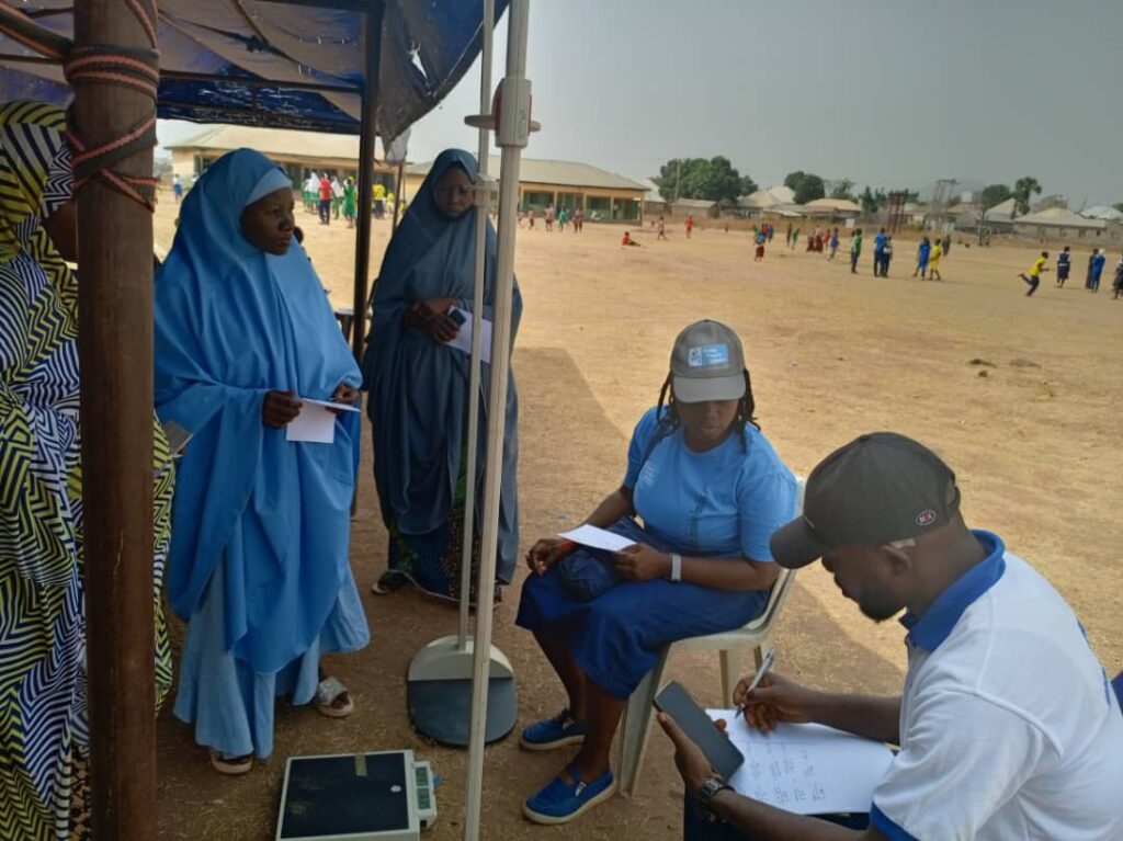 Conducting health check in Takushara Community