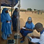 Conducting health check in Takushara Community