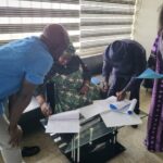 The CEO of WFI Signing the MOU to handover the waterless and ordourless toilet to Area Counil Government