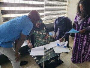 The CEO of WFI Signing the MOU to handover the waterless and ordourless toilet to Area Counil Government